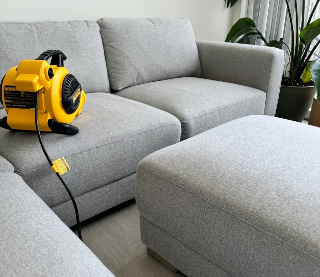 Couch and ottoman prepared for professional upholstery cleaning service
